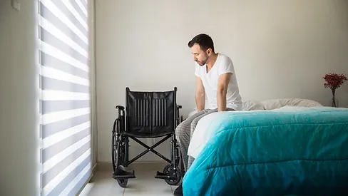 patient looking at wheelchair from edge of the bed