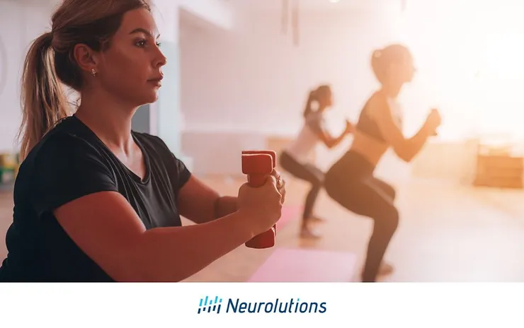 woman holding hand weights while working out