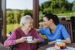 Care partner having tea with stroke survivor